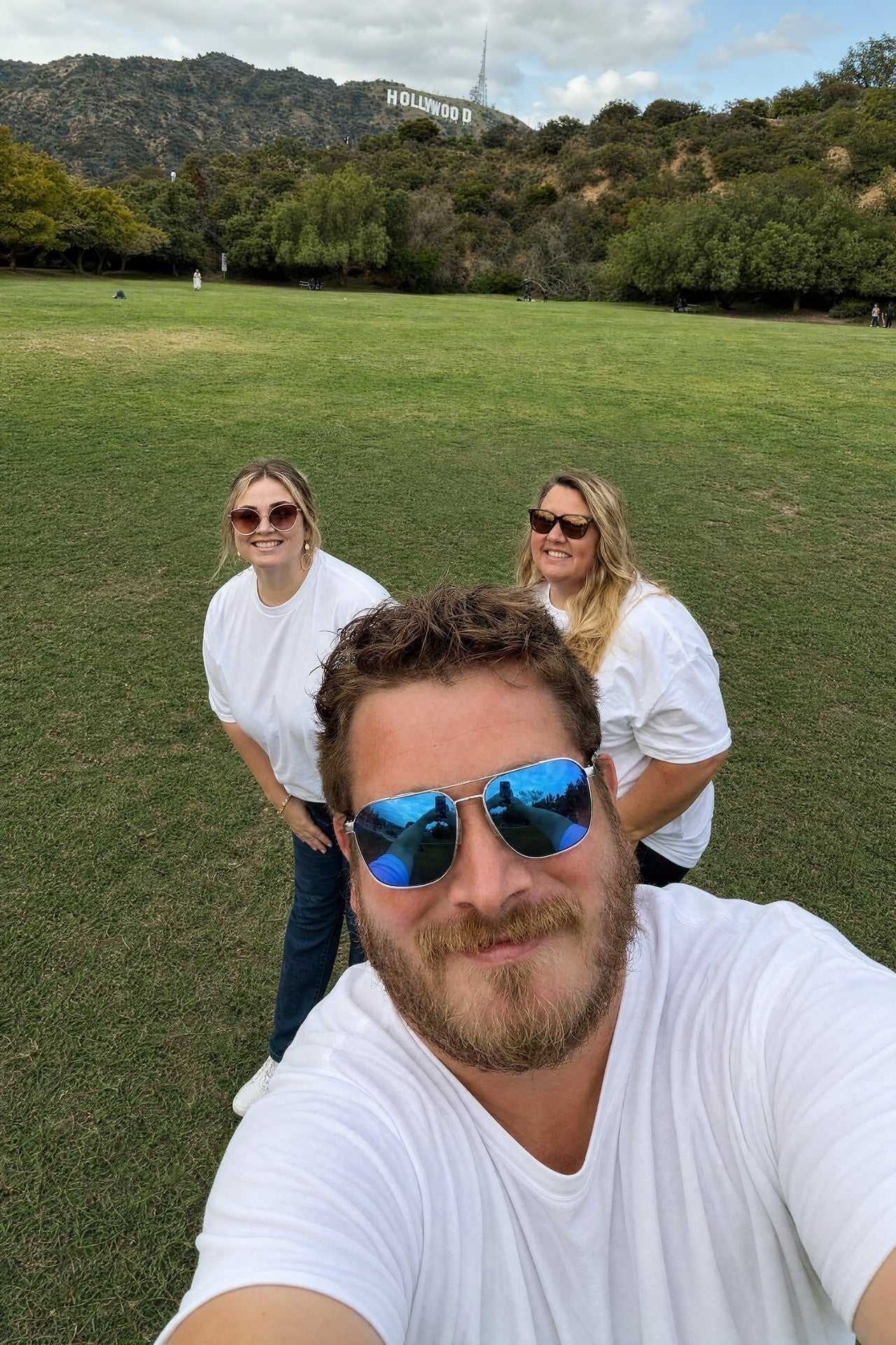 Alicia, Marie and Mark — the founders of The Loaded Tea Shop — under the Hollywood sign